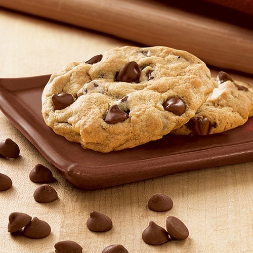 Chocolate chip cookie sitting on a brown dish